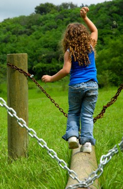 Girl balancing on a log