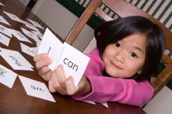Girl holding sight words flash cards Girl holding sight words flash cards